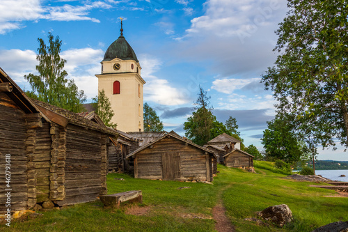church and wooden cabins in the Swedish countryside