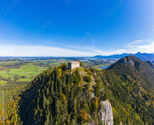 Germany, Bavaria, Pfronten, Aerial view of ruins of Falkenstein Castle standing on top of forested Falkenstein mountain photo