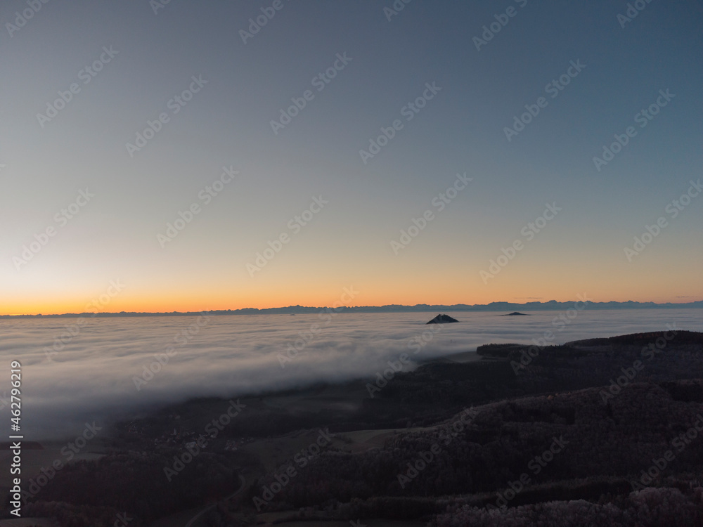 Clear sky over landscape shrouded in thick morning fog Clear sky over landscape shrouded in thick morning fog