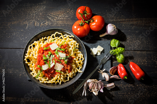 Pasta al Pomodoro, fusilli lunghi with tomato sauce, garlic, basil, parmesan cheese and red peppers