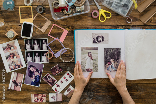 Top view of woman's hands designing photo album
