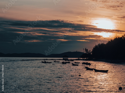 Silhouette of boats in sunset. Fantastic blue sky turns into golden sunset. Gulf of Thailand..