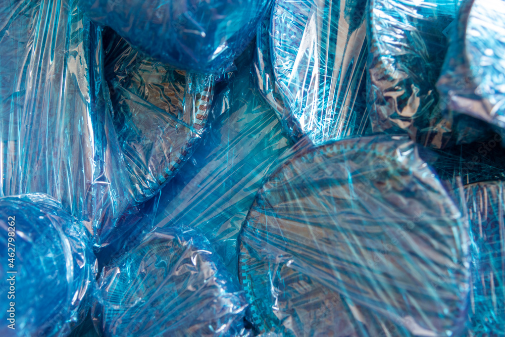 Glassware wrapped with blue wrapping nylon at the bottom of a cardboard box. High quality photo