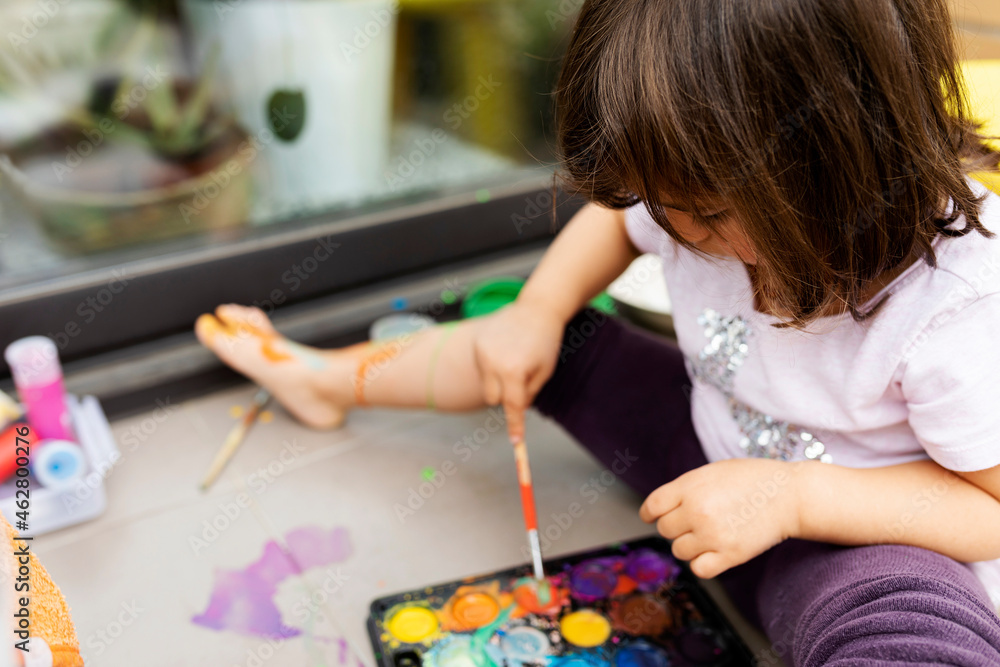 Little girl painting with watercolors Stock Photo | Adobe Stock
