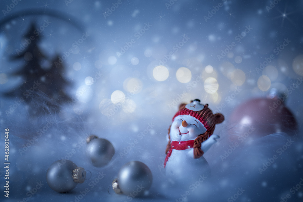 Happy snowman with christmas balls in winter christmas landscape. Snowy background.