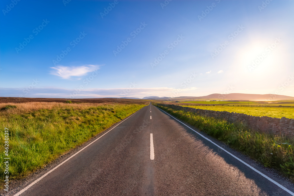 Scotland, Orkney Islands, South Ronaldsay, Empty road crossing rural landscape