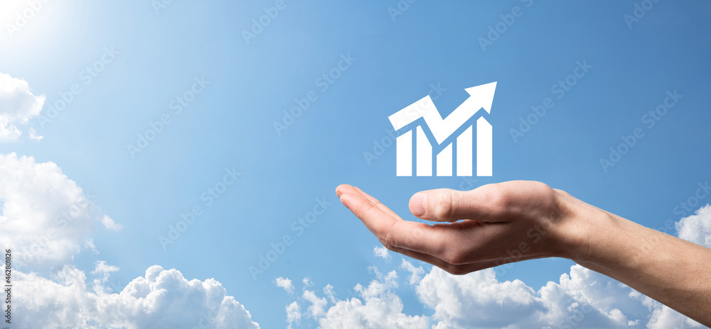 Naklejka premium Male hand holding smart mobile phone with graph icon.checking analyzing sales data growth graph chart and stock market on global networking. Business strategy, planning and digital marketing