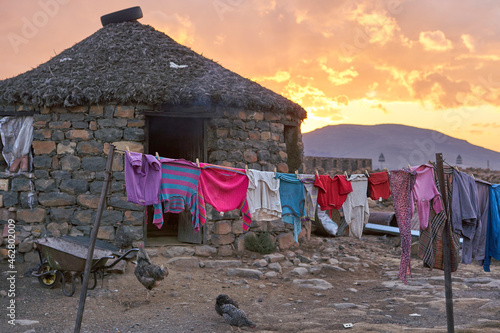 Sunset at a typical house with hanging clothes, Lesotho, Africa