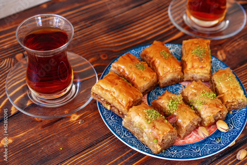 Turkish sweet baklava with Turkish tea on wooden background