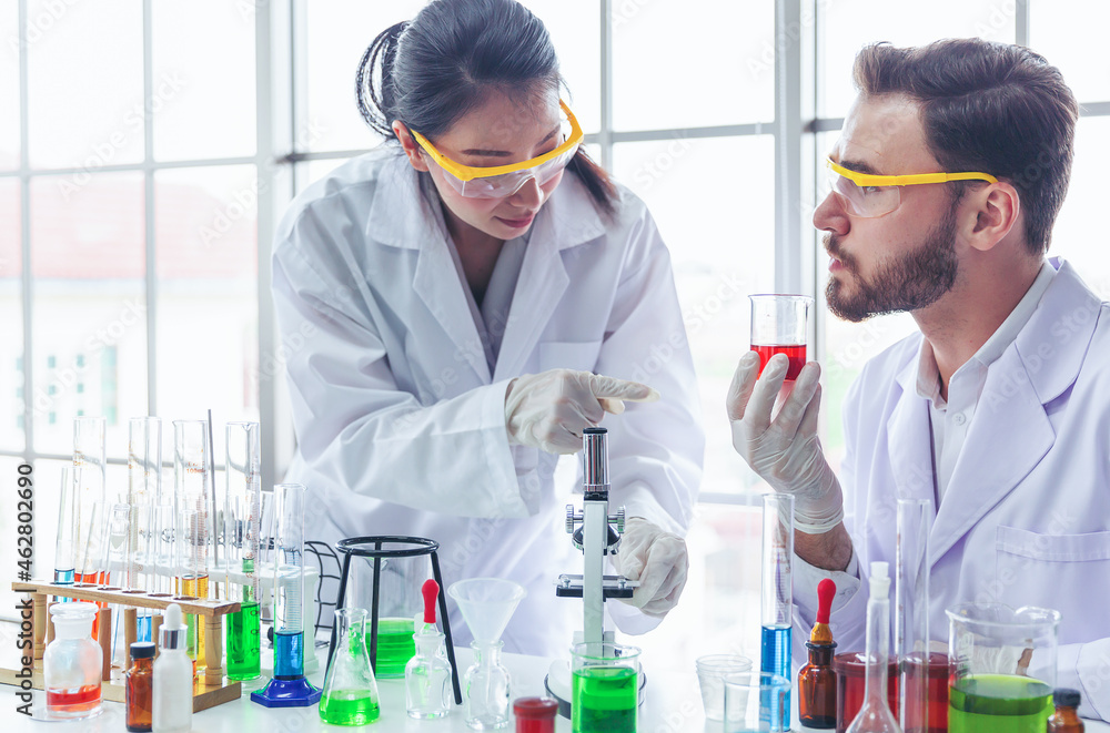 Two scientists are researching and developing drugs for the treatment of diseases in the laboratory. Equipment,Scientific and healthcare concept. Two scientists are researching and developing drugs for the treatment of diseases in the laboratory. Equipment,Scientific and healthcare concept.