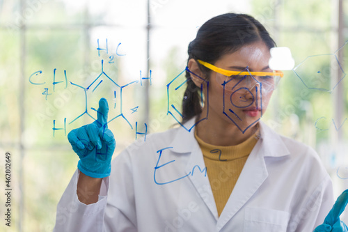 Asian female scientists doing chemistry scientific formula and analysis biochemistry structure in the laboratory. Female specialist working at lab. Woman researcher at laboratory