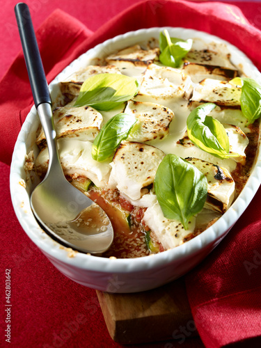 Courgette gratin with goat cheese, sesame in gratin dish, low carb photo