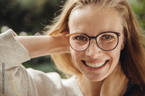 Portrait of happy young woman with glasses photo