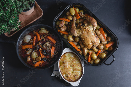 Chicken a la Coq au Vin with onion gratin, red vine sauce and baked potato