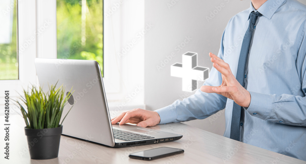 Businessman hold 3D plus icon, man hold in hand offer positive thing such as profit, benefits, development, CSR represented by plus sign.The hand shows the plus sign Businessman hold 3D plus icon, man hold in hand offer positive thing such as profit, benefits, development, CSR represented by plus sign.The hand shows the plus sign