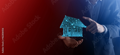 Man hold low polygon.Real estate concept, businessman holding a house icon.House on Hand.Property insurance and security concept. Protecting gesture of man and symbol of house