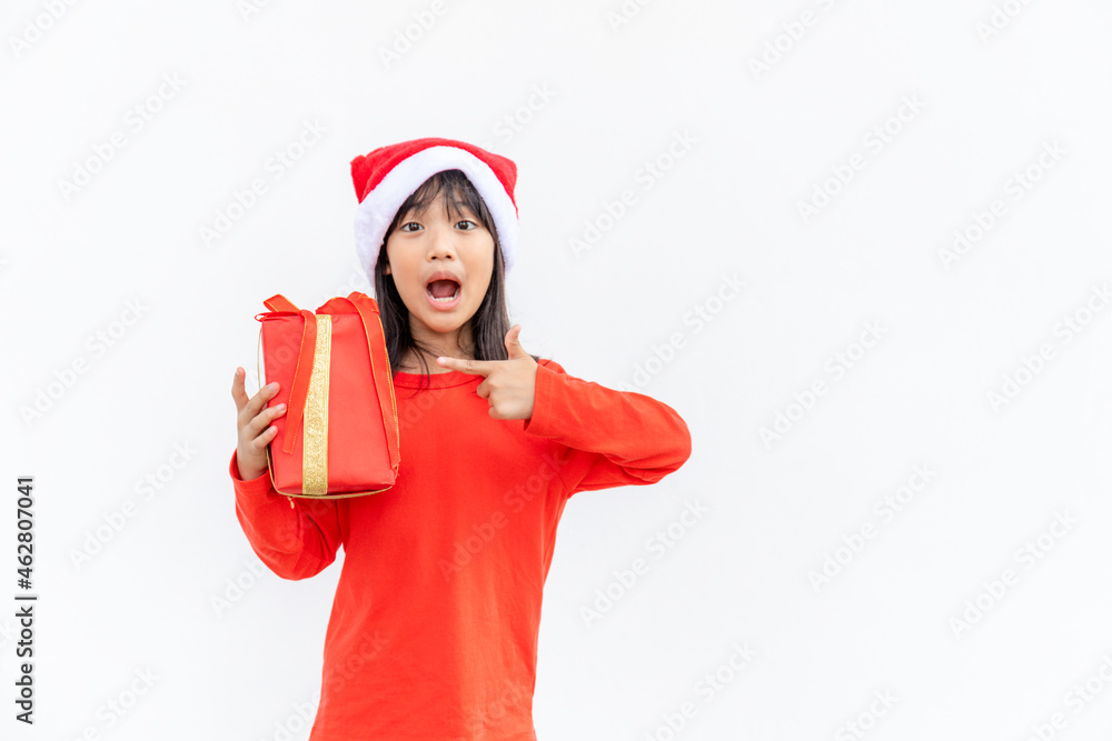 Happy Asian child in Santa red hat holding Christmas presents. Christmas time.on white background. Happy Asian child in Santa red hat holding Christmas presents. Christmas time.on white background.