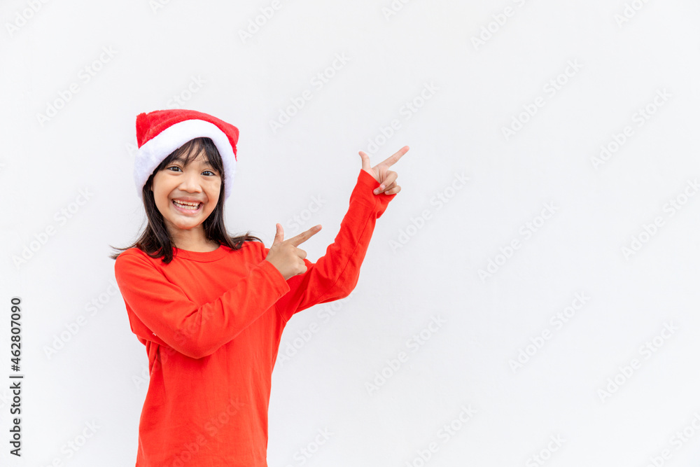Asian little girl in red Santa hat on white background.