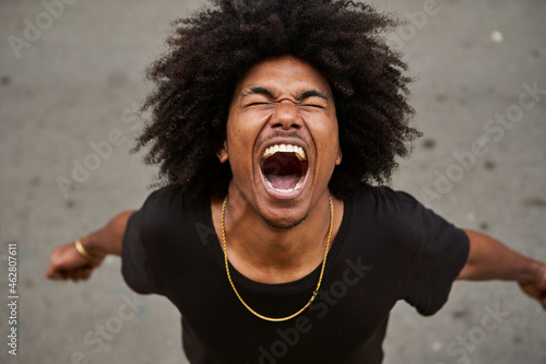 Portrait of screaming young man with afro photo