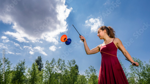 Young woman juggling with diablo photo