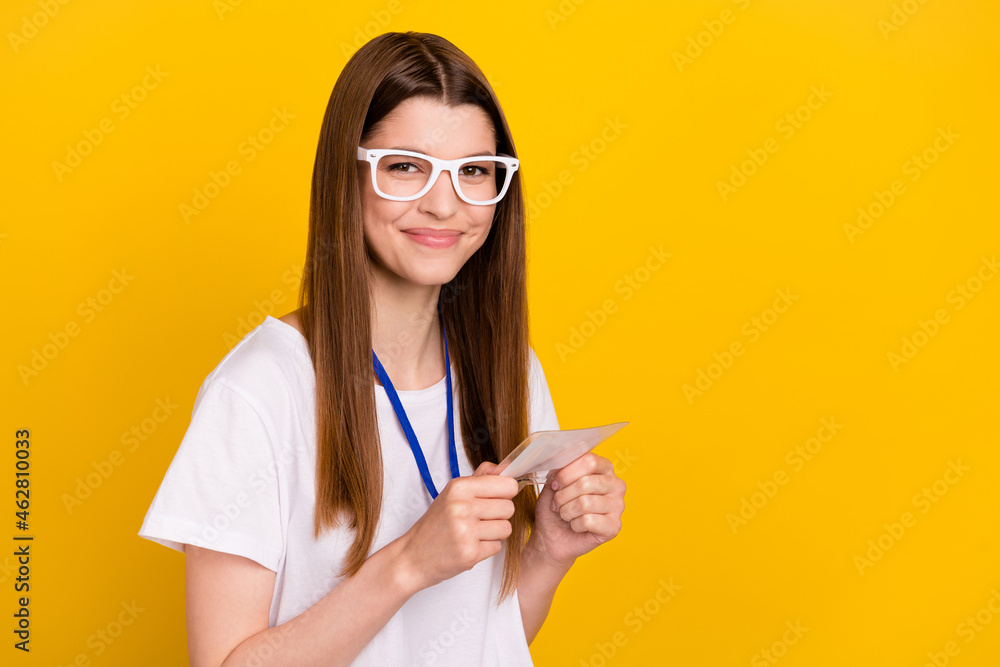 Photo of charming happy positive woman wear glasses hold name tag isolated on yellow color background