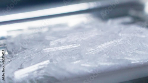 Pour the crystals into the stainless steel tray