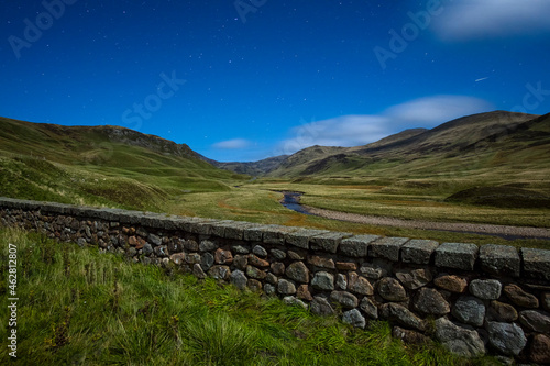 UK, Scotland, Glenshee, landscape with stone wall under starry sky