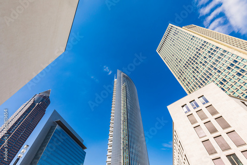 Low angle view of skyscrapers against blue sky, Frankfurt, Hesse, Germany photo