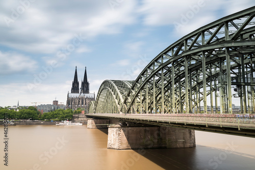 Germany, Cologne, view to Cologne Cathedral with Hohenzollern Bridge and River Rhine in the foreground photo