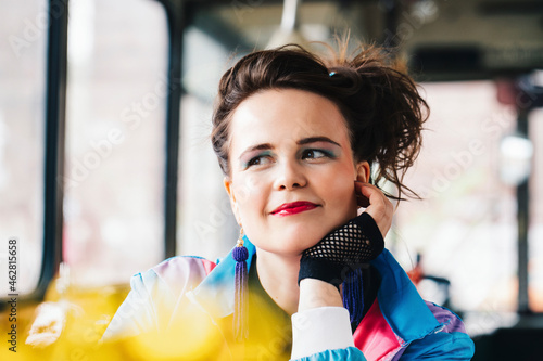 1980s retro-styled woman sitting in an old bus