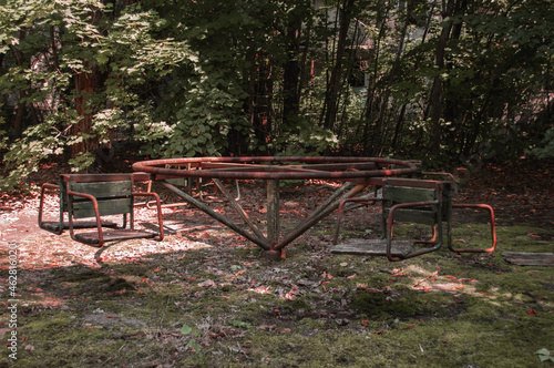 A radioactive abandoned  playground overgrown with trees in the city of Pripyat