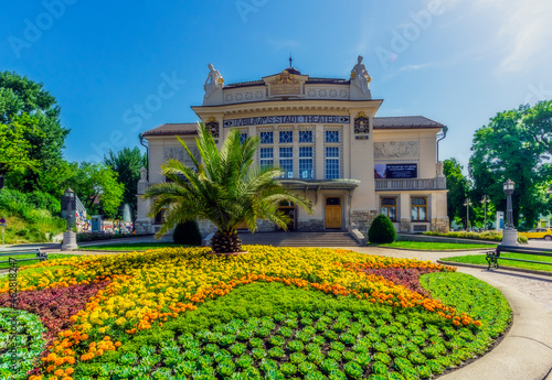 Austria, Carinthia, Klagenfurt, Stadttheater Klagenfurt with flowerbed in foreground photo