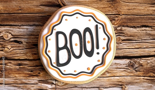 Boo! - Halloween cookie on wooden background - 3D illustration.