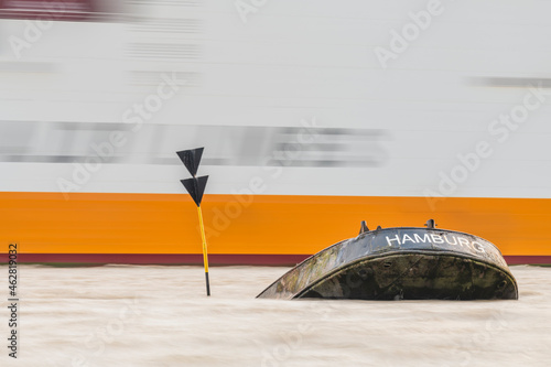 Germany, Hamburg, Blankenese Container ship passing by Uwe shipwreck photo