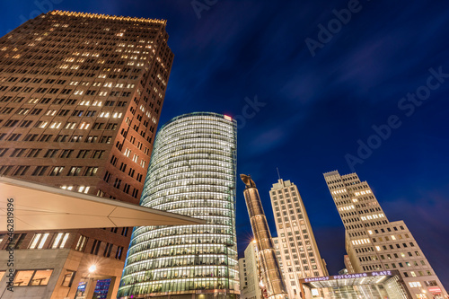 Germany, Berlin, Mitte, Potsdamer Platz, Kollhoff-Tower, Bahntower, Beisheim-Center, Low angle view of skyscrapers at dusk photo