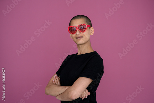 Portrait of a confident woman wearing heart-shaped sunglasses photo