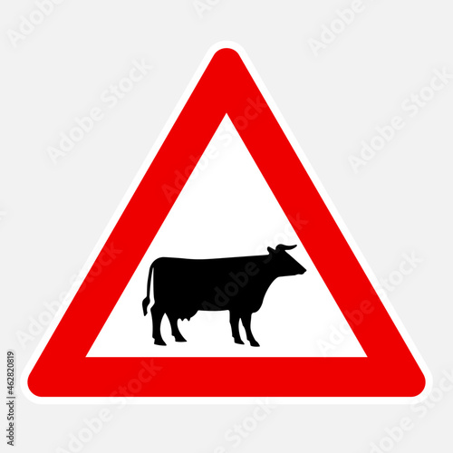 Domestic animals (cow black silhouette) ahead vector danger road sign