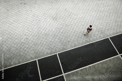 Germany, Hessen, Offenbach, person walking on sidewalk photo