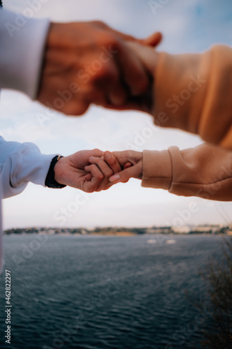 a man and a woman in love at sunset, on the sea embankment