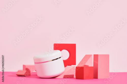 white mockup jar of cream on a pink podium on a pink background, bottles for perfume or serum