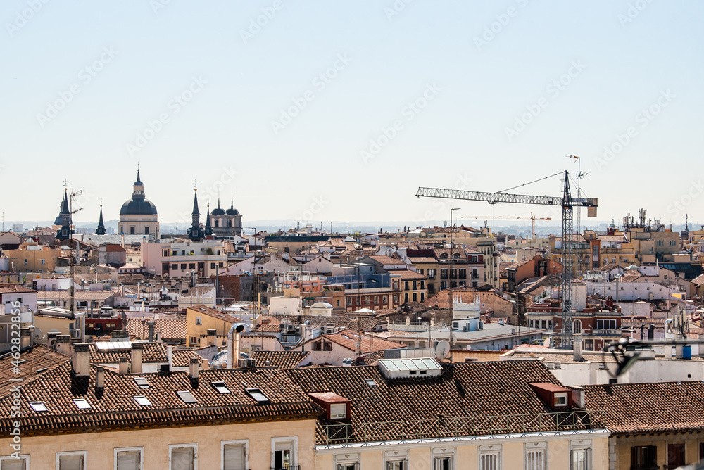 View of the La Latina neighborhood, in Madrid, the roofs of the houses and a crane in a day without pollution