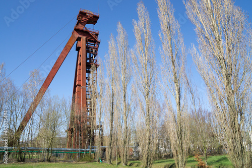 Germany, North Rhine-Westphalia, Kamen, Low angle view of abandoned shaft tower standing against clear sky photo