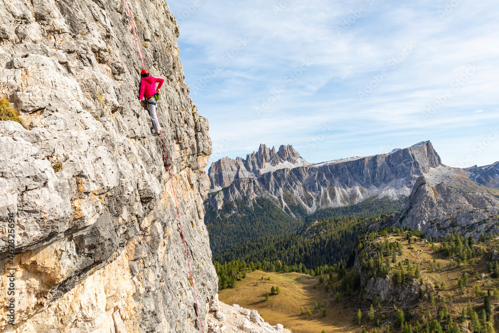 Italy, Cortina d'Ampezzo, woman using chalk poweder while climbing in the Dolomites mountains Italy, Cortina d'Ampezzo, woman using chalk poweder while climbing in the Dolomites mountains