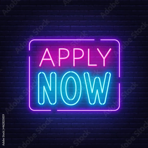 Apply Now neon sign on a brick wall background.