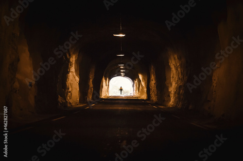 Norway, Lofoten Islands, Maervoll, silhouette of man at the end of a tunnel photo