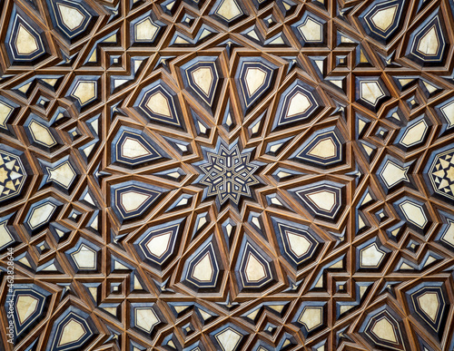 Closeup of wooden arabesque decorations tongue and groove assembled, inlaid with ivory and ebony, on Minbar of historic public Mosque of Al Rifai, Old Cairo, Egypt