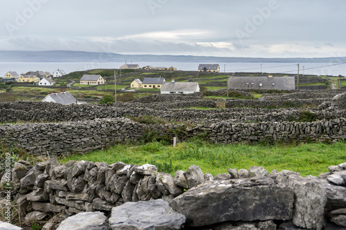 many stone walls on green grass dividing little farms photo