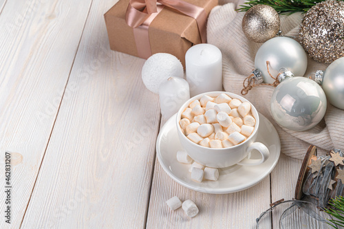 Coffee, Christmas balls and candles on a light background with space to copy.