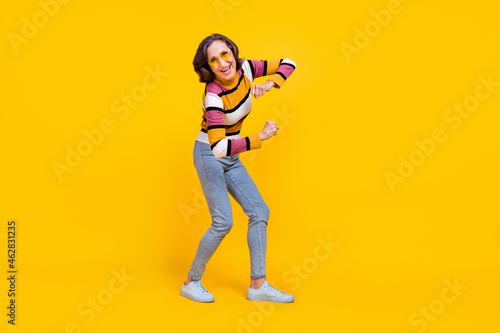 Full body photo of lovely white hairdo elder lady dance wear eyewear sweater jeans footwear isolated on yellow color background