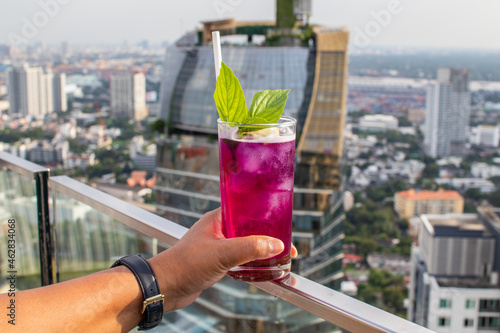 Canvas Print A refreshing, delicious cocktail mixed with several berries over the roofs of Ba